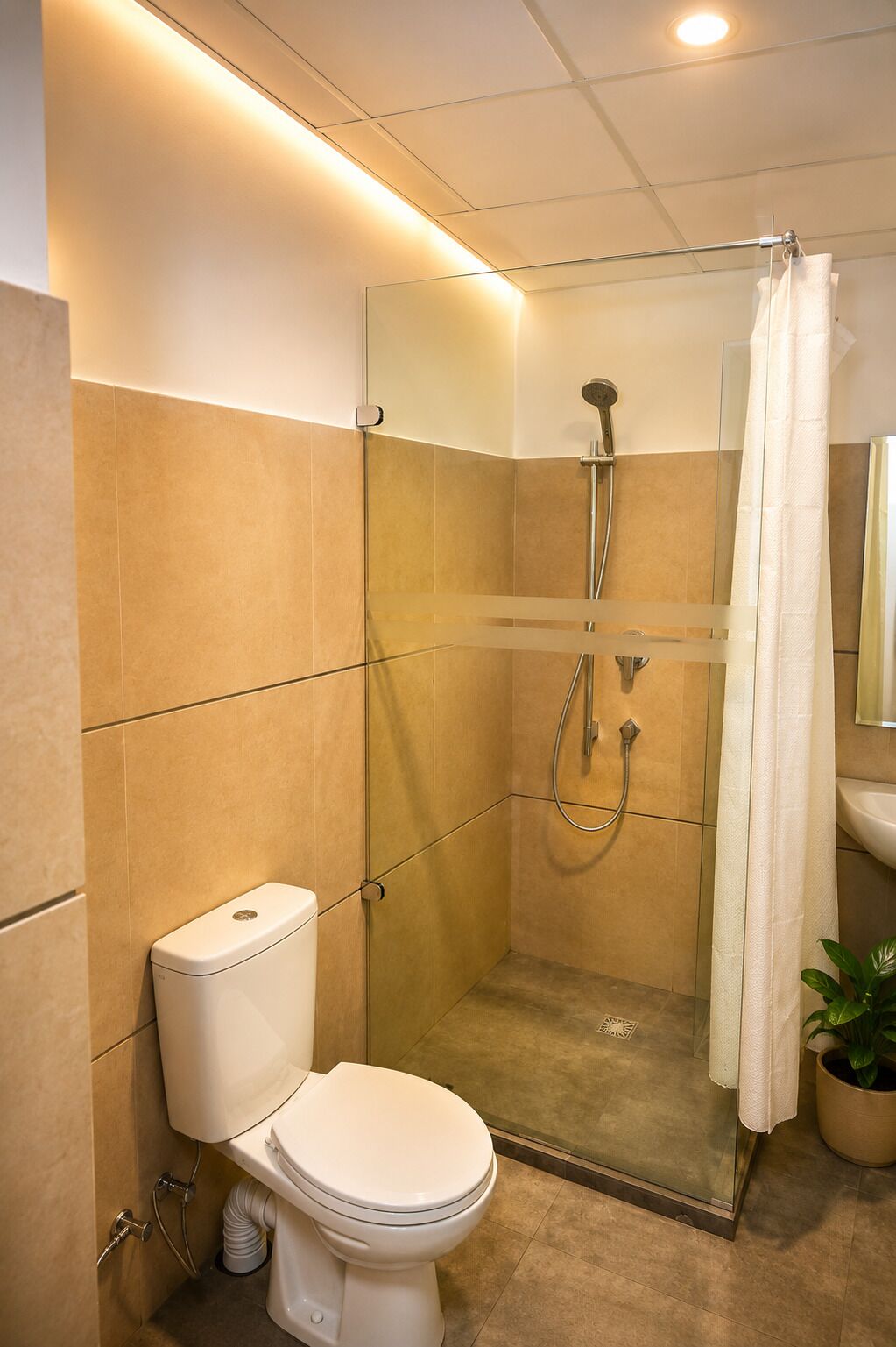 A modern bathroom with a glass-enclosed shower, a toilet, and a sink.