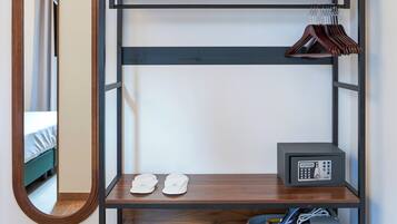 A bunk bed with a mirror, a shoe rack, and a radio on the lower shelf.