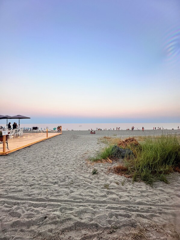 On the beach, black sand, 2 beach bars