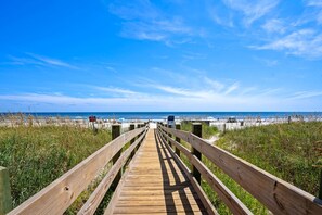 A wooden boardwalk leading to a beach with clear skies. - 10% off 3-7 nights Oct- Dec. San A Bel 406 Cozy oceanfront condo. Crescent Beach. (North Myrtle Beach)