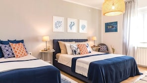 A hotel room with two beds, a nightstand, a lamp, and wall art. - Villa La Vidas by Villas Guide (Medulin)