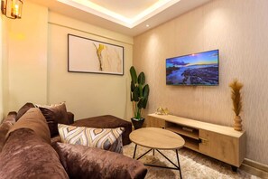 Classic Apartment, Patio, City View | Living area | 55-inch Smart TV with cable channels, Netflix, first-run movies - Moonvalley View Palace Apartment (Nairobi)