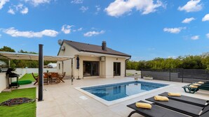 A modern house with a swimming pool, outdoor seating, and a covered patio area. - Villa Shaula 2 by Villas Guide (Sibenik)