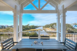 Outdoor dining - Experience oceanfront luxury at Tortuga by the Sea in Oak Island, NC. (Oak Island)