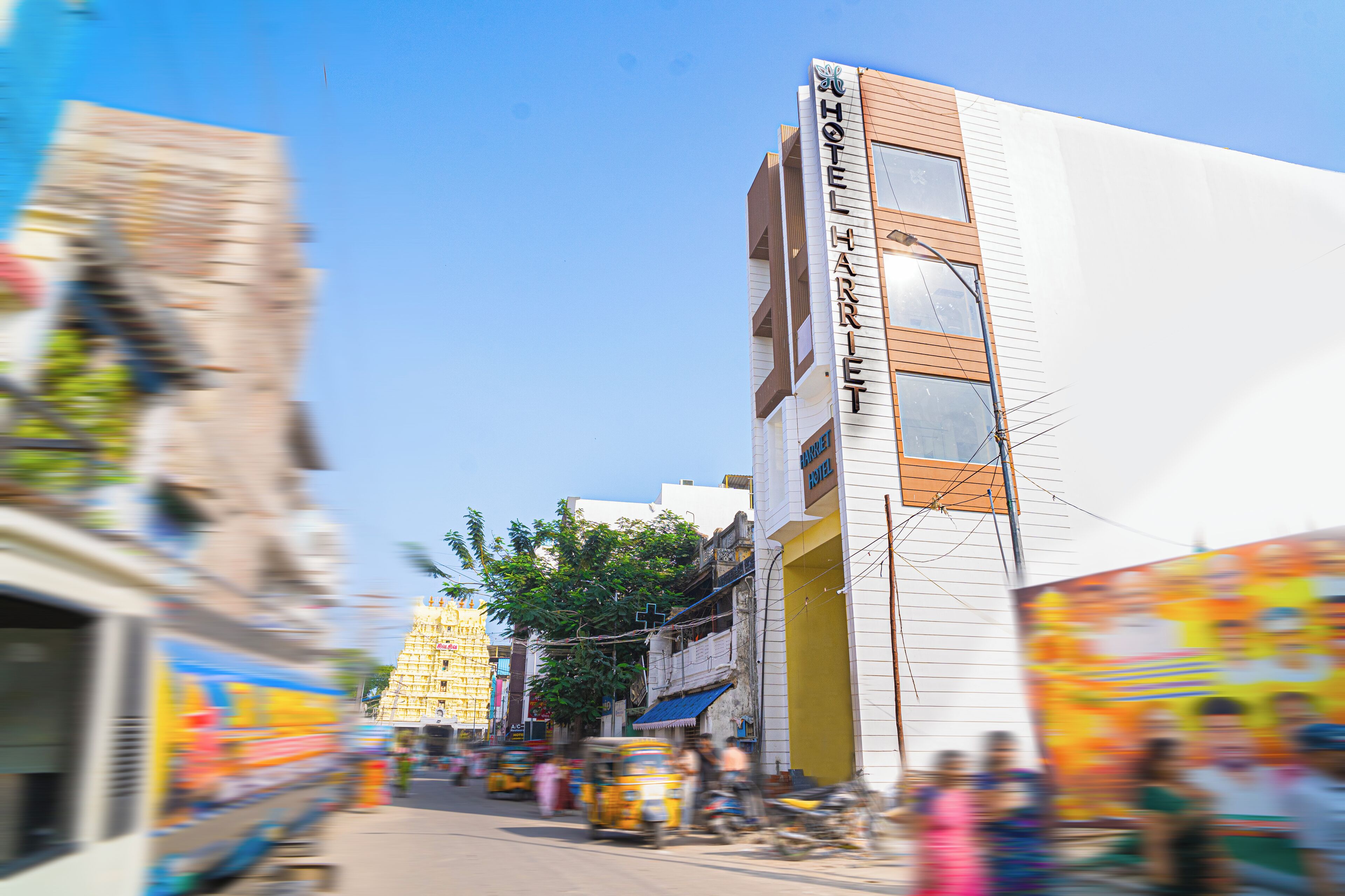 A hotel named "Hotel Harriet" with a modern facade, multiple windows, and a visible entrance.