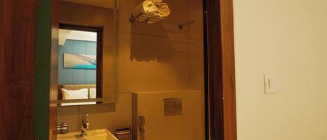 A bathroom with a sink, mirror, towel rack, and a shower.