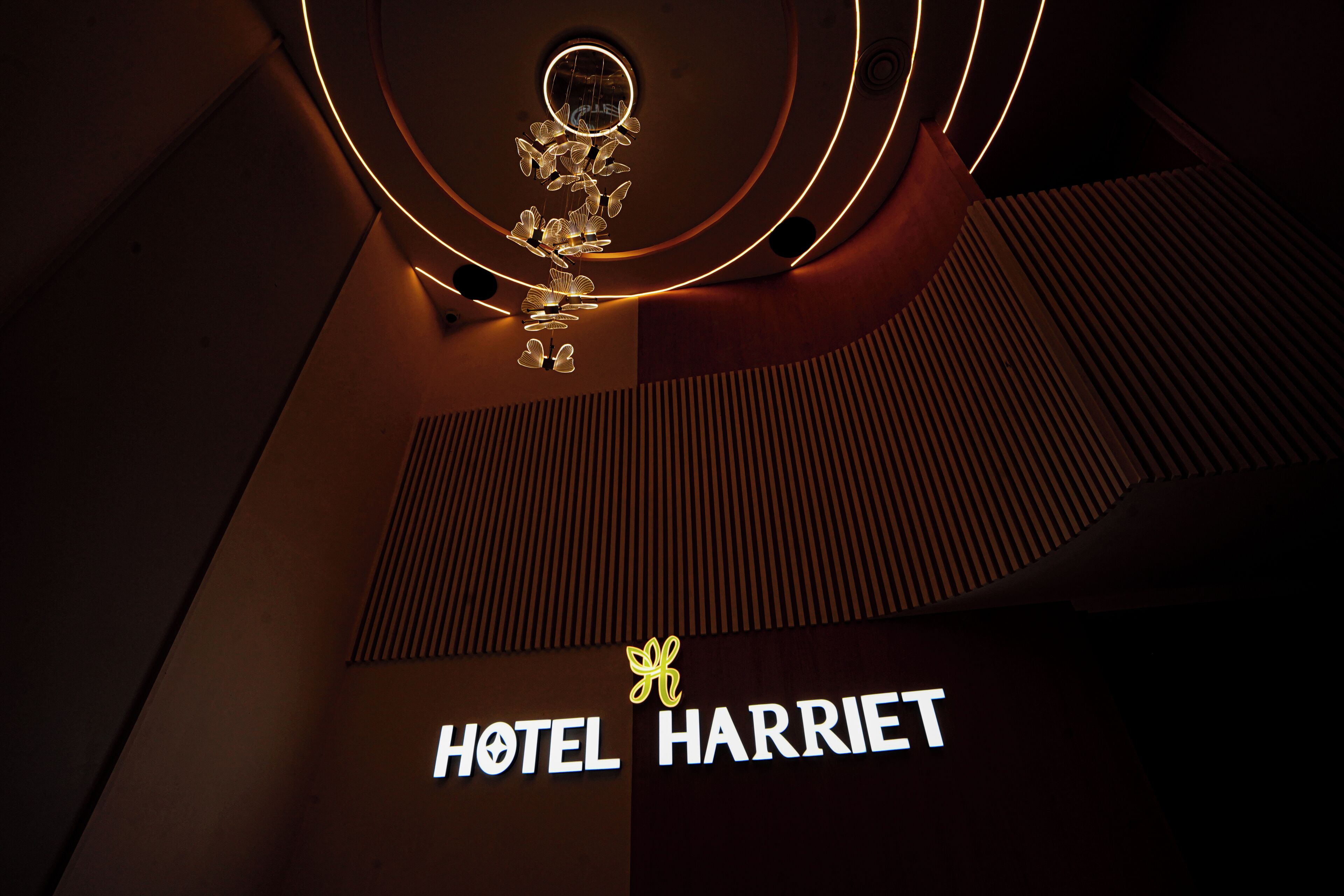 A hotel sign with a circular light fixture above it.