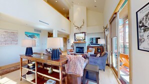 A spacious living area with a fireplace, comfortable seating, and a large window offering a view of the outdoors. - Elkhorn Springs 15 - Luxury w/ Great Views, Walk to Pool, Tennis, Golf (Elkhorn)