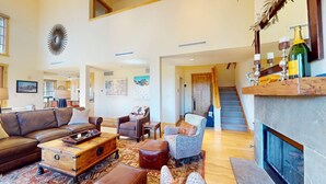 A spacious living room with a fireplace, leather furniture, and a staircase leading to an upper level. - Elkhorn Springs 15 - Luxury w/ Great Views, Walk to Pool, Tennis, Golf (Elkhorn)