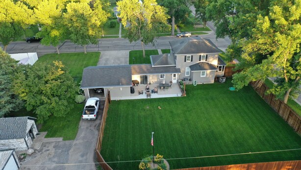 A residential house with a well-maintained lawn, a driveway, and a garage. - Hometown Haven
quiet•peaceful•cozy (Hancock)