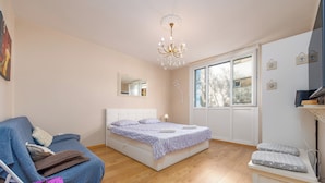 A bedroom with a bed, a chair, a desk, and a window. - Apartment Oasis with Sea View (Zadar)