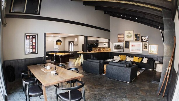 A modern interior with a dining area, sofa set, and kitchen in the background. - Chamonix 33: Close to Canyon Lodge (Mammoth Lakes)