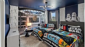 A Star Wars-themed bedroom with a bed, Star Wars posters, and a unique ceiling design. - ChampionsGate Resort 10 Bedroom Vacation Home - Includes resort clubhouse amenity access! 10 Home (Davenport)