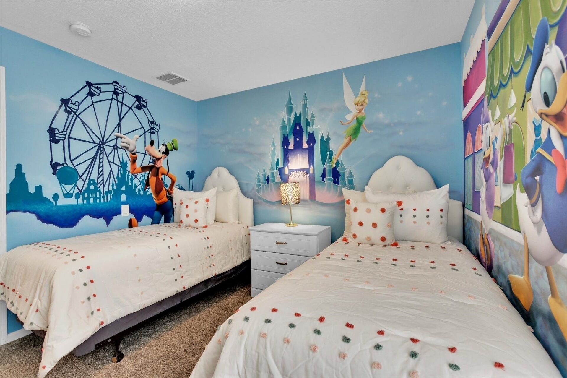 A bedroom with two beds, a mural of a Ferris wheel and a castle, and a fairy next to a sleeping character.