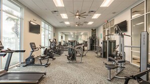 A gym with treadmills, elliptical machines, and weightlifting equipment. - Windsor Island Resort 5 Bedroom East Facing Pool 5 Home (Davenport)