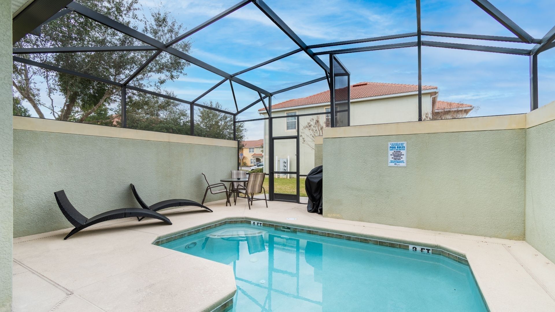 A pool area with a glass enclosure, a pool table, and a sign indicating pool rules.