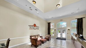 A spacious lobby with a Tuscan-themed sign, a patterned floor, and a reception desk. - Tuscana Resort 2 Bedroom Condo Clubhouse Access 8 miles to Disney 2 Condo (Davenport)