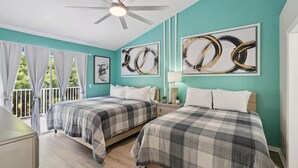 A bedroom with two beds, a ceiling fan, and artwork on the walls. - Royal Palm Bay 3-Bedroom Vacation Condo with Amenity Access 3 Condo (Kissimmee)