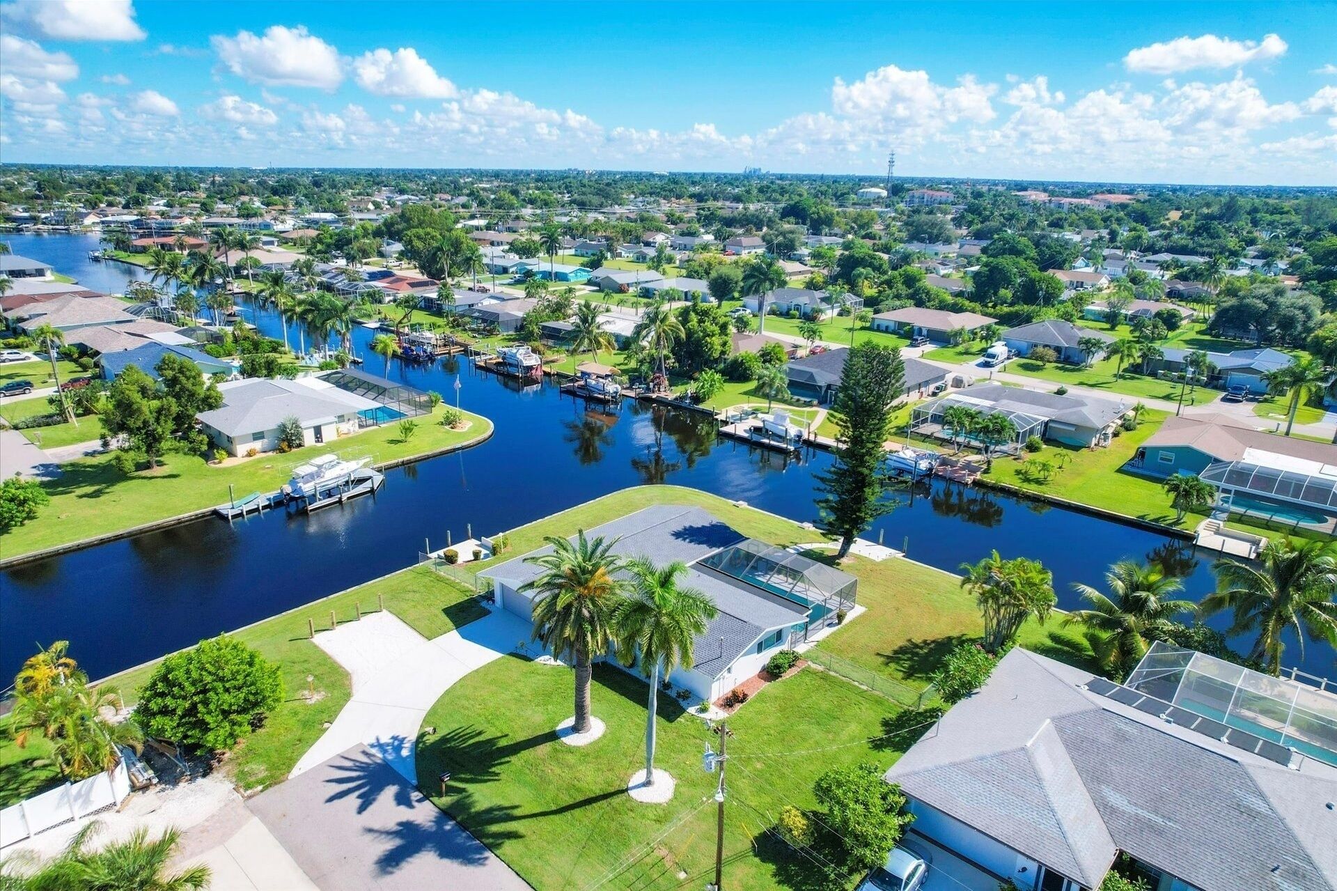 A residential area with houses, a canal, and a boat dock.