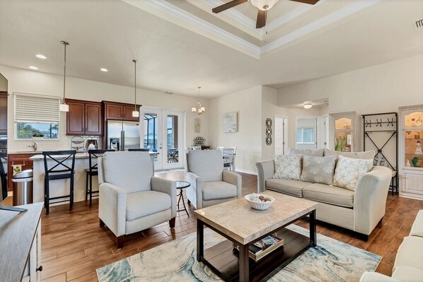 A spacious living area with a sofa, armchairs, a coffee table, and a dining area with a table and chairs. - South Gulf Cove 3 Bedroom Canal Pool Home 3 Home (Port Charlotte)