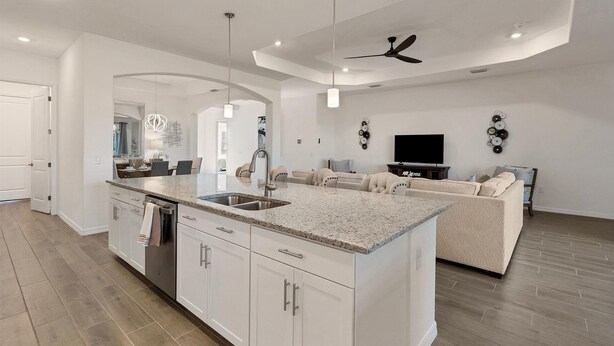 A spacious kitchen with a large island, white cabinetry, and a dining area with a chandelier. - Heritage Landing Golf Club - Private 3 Bedroom Home - Amenities Included! 3 Home (Punta Gorda)