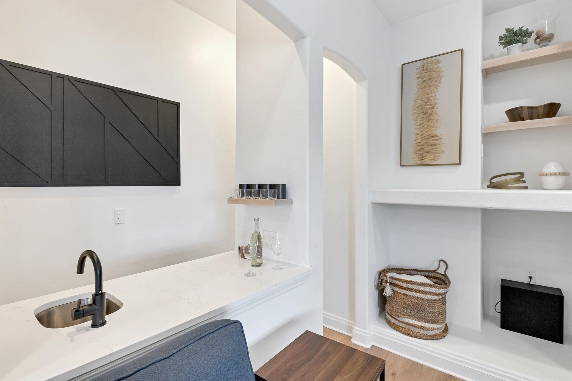 A modern kitchen with a built-in sink, a countertop, and a wall-mounted cabinet.