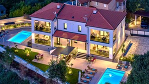 A modern two-story house with a swimming pool, outdoor seating, and a well-maintained garden. - Villa Polaris by Villas Guide (Pula)