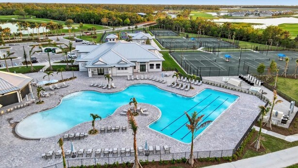 A resort with a large pool, multiple tennis courts, and a golf course in the background. - Heritage Landing Resort 30 night minimum 3 Bedroom Condo 3 Condo (Punta Gorda)