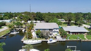 A marina with boats docked, a large building with a flat roof, and surrounding greenery. - Lemon Bay Waterfront Condo W Patio, 5 Miles To Gulf Beaches 2 Bedroom Condo (Englewood)