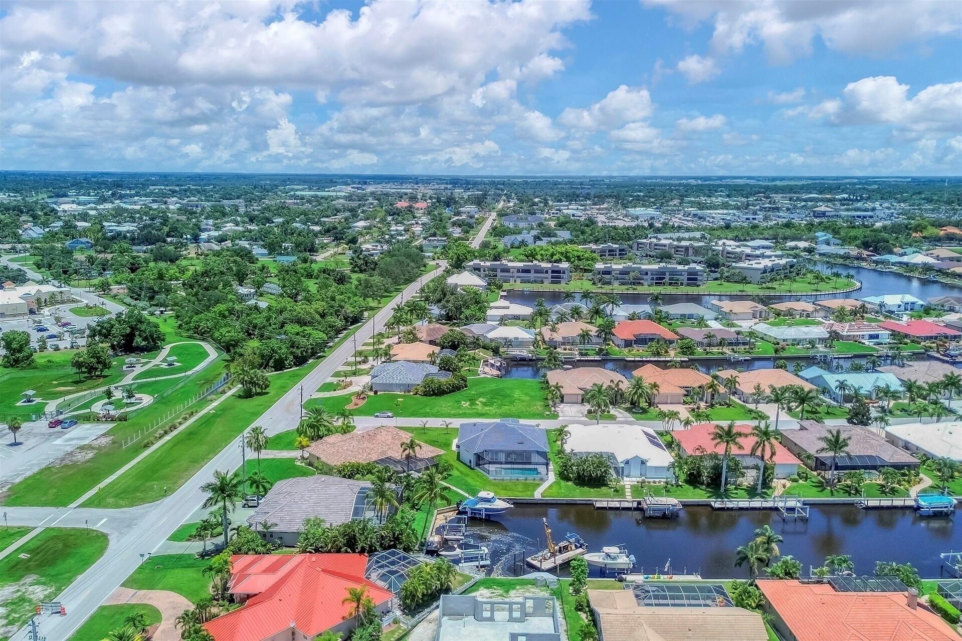 A residential area with houses, a marina, and a large body of water.