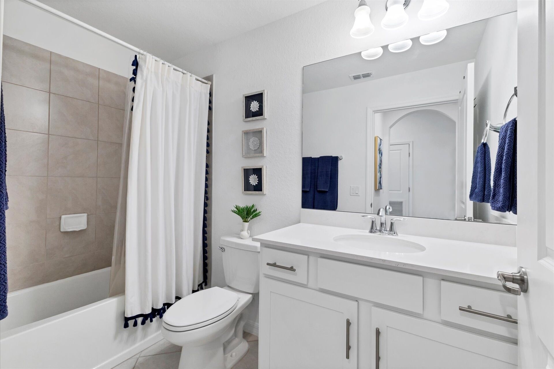 A modern bathroom with a shower, toilet, and vanity.