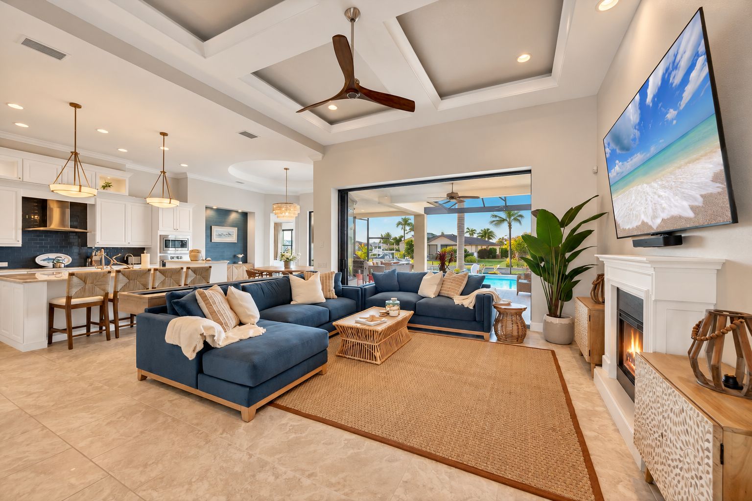 A spacious living area with a large sofa set, a fireplace, and a television mounted on the wall.