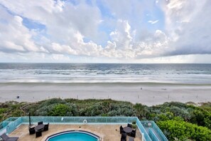 A pool area with a view of the beach and ocean. - Oceanfront Condo With Beautiful Views 2 Bedroom Condo (New Smyrna Beach)