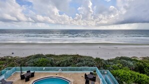 A pool area with a view of the beach and ocean. - Oceanfront Condo With Beautiful Views 2 Bedroom Condo (New Smyrna Beach)