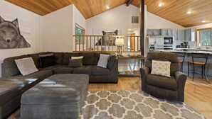 A modern living room with a sectional sofa, a recliner, and a patterned rug. - Tan Oak 2 3 Bedroom Home (Bend)