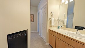 A bathroom with a sink, mirror, towel rack, and a hairdryer. - Mt Bachelor Village 328 B 1 Bedroom Condo (Bend)