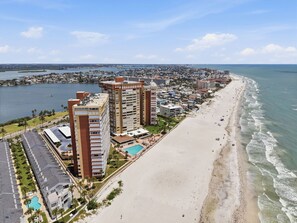 A coastal cityscape with high-rise buildings, a sandy beach, and a marina. - ☀Beachfront Condo🌴Wrap Around Private Balcony🐬Redington Towers 3A🌞Heated Pool (Redington Shores)