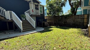 A backyard with a wooden deck, a staircase, and a fenced area. - 4 Blocks to Beach/Pleasure Pier-1 Block off parade route-KING Suite-Allow Pets (Galveston)