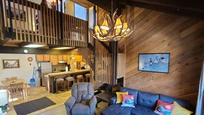 A modern interior with a kitchen, dining area, and living room. - Aspen View Lodge 4 bed/3 ba, Sauna, W/D, Views (Brian Head)