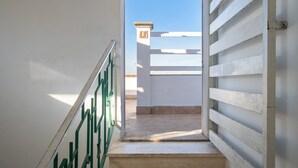 Una escalera que lleva a un espacio al aire libre con cielo despejado.