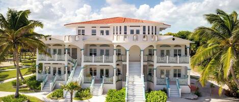 A large, multi-story hotel with a symmetrical facade, multiple balconies, and a central staircase.