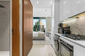 Fridge, microwave, oven, stovetop - Minimalist Studio in Binghatti Azure (Jumeirah Village Circle (JVC))
