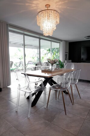 Dining - Experience modern waterfront living in Cape Coral’s Yacht Club district. Walk to the beach for stunning sunsets, plug in with on-site EV charging, and keep your boat moored at our private backyard dock. Direct gulf access with no bridges! (Cape Coral)