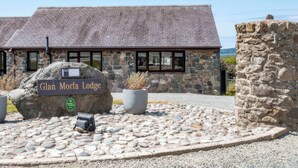 A stone building with a sign reading "Glan Moria Lodge." - Blue Bird Cottage (Gaerwen)