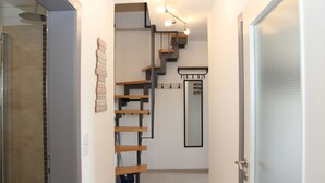 A modern interior with a staircase, a shower area, and a door with frosted glass. - Holiday Apartment “Olsberg” with Mountain View, Private Terrace and Wi-Fi (Olsberg)
