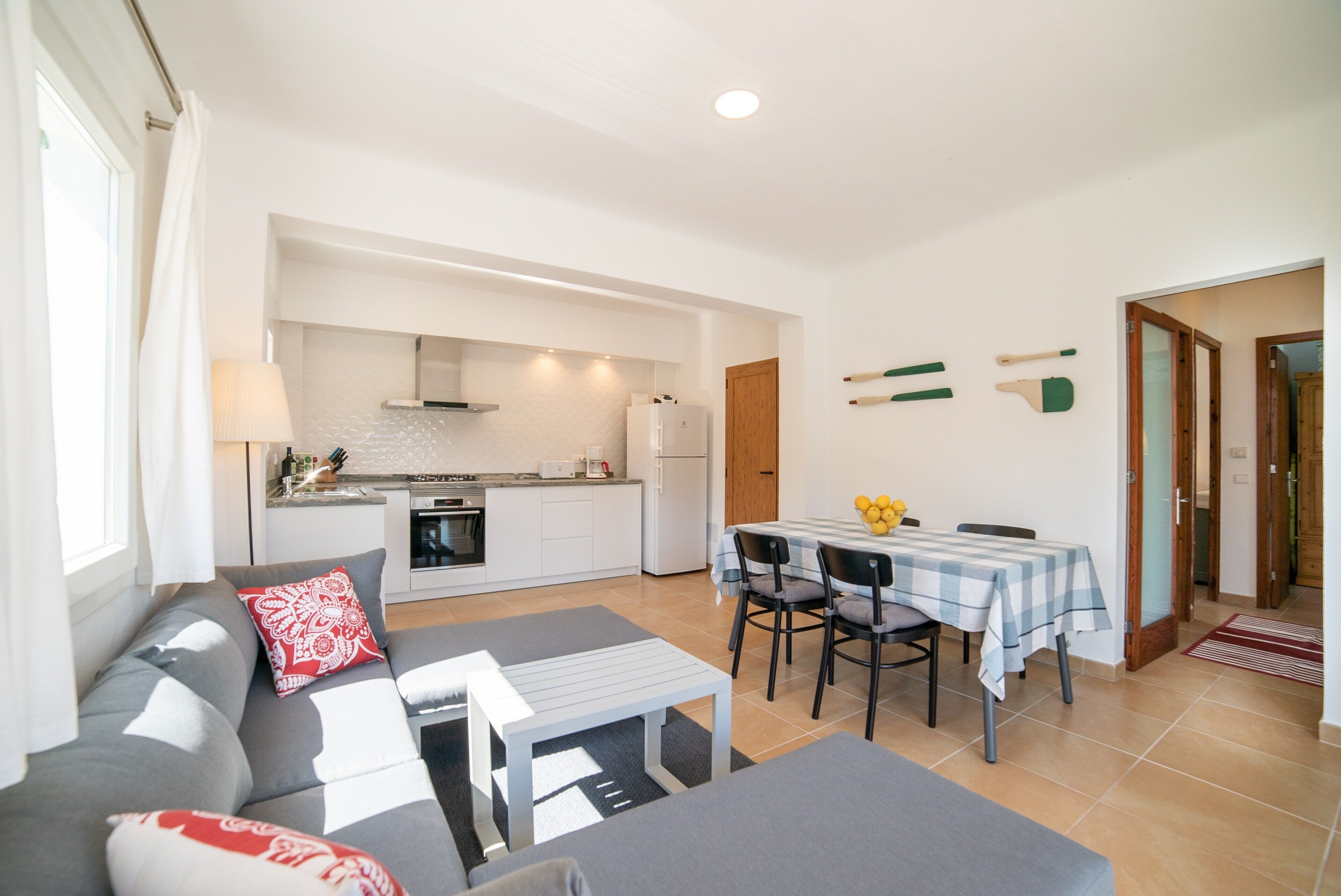 A modern apartment with a living area, kitchen, and dining space.