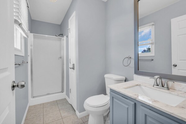 A bathroom with a shower, toilet, and vanity. - Seaside Park Beach Home | 3BR w/ Deck, Peloton, Parking + 6 Beach Passes (Seaside Park)