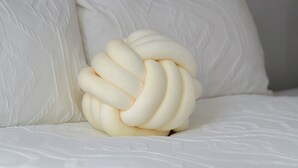 A bed with a unique, spherical white pillow. - POOL TABLE/ CINEMA ROOM/ WEEKLY DISCOUNTS (Glasgow)