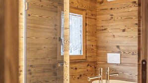 A wooden cabin bathroom with a large white vessel sink, a wooden vanity, and a wooden bathtub. - Poligrafica 1 House, quiet and comfortable (Cortina d´Ampezzo)