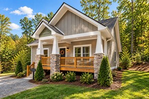 A two-story house with a stone foundation, a wooden deck, and a front porch. - Immaculate Cottage, Clean Hot Tub, 2 Miles to Asheville (Asheville)